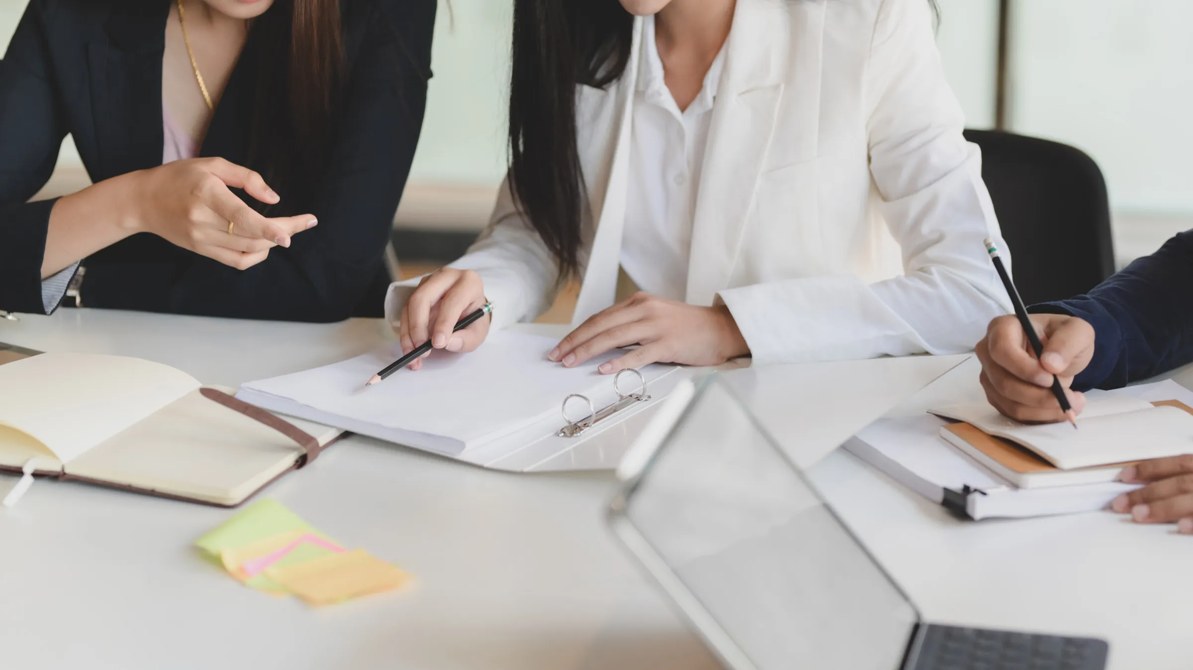 Two people reviewing documents together at a desk